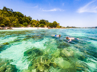 couple snorkeling in clear blue sea