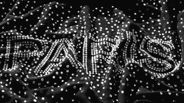 shiny letters Paris on a black background