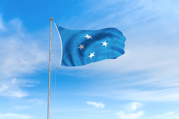Federated States of Micronesia flag over blue sky background