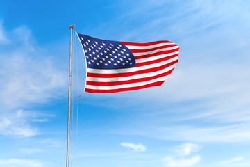 United States flag over blue sky background