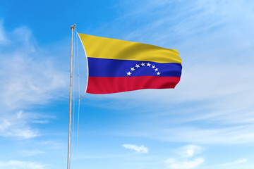 Fototapeta na wymiar Venezuela flag over blue sky background