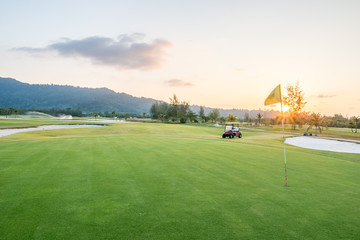 The golf course landscape with beautiful sky. Golf cart at the green golf course