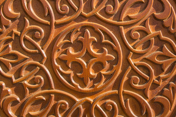 pattern on a wooden surface with deep relief and shadows. rough texture