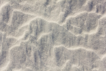 white snow surface with relief and shadows. natural texture