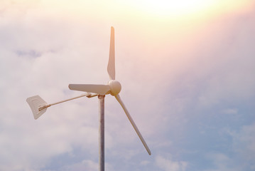 Small wind turbine on sky with cloud as background © surasak