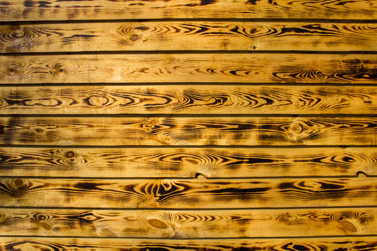 yellow brown fence wall of natural wooden boards. horizontal lines. rough surface texture