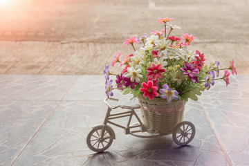 Fototapeta na wymiar plastic toy bicycle decorating with flowers