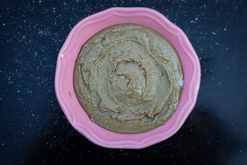 Homemade sunflower seeds butter spread on black background in bowl. Close up. Smooth dip paste.
