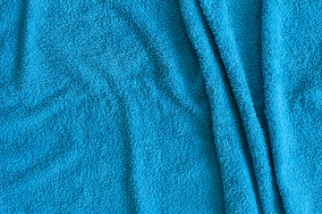 Fototapeta na wymiar Top view of Blue Towel texture. Blue Towel Fabric Texture Background. Close-up. Blue natural cotton towel background.Space for text. Hygiene, fabric, laundry,spa and textile concept.