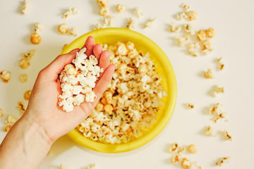 Tasty salted popcorn in bowl on white background. Flat lay of pop corn bowl. Top view. Pop corn-Close up