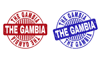 Grunge THE GAMBIA round stamp seals isolated on a white background. Round seals with grunge texture in red and blue colors. Vector rubber imprint of THE GAMBIA title inside circle form with stripes.