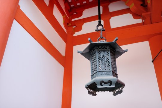 A traditional black iron lantern against the walls