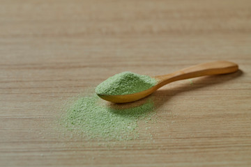 Wooden spoon with powdered matcha green tea