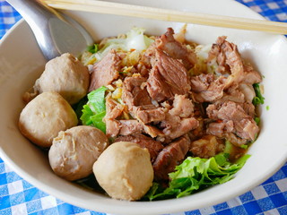 Closeup of fresh noodles soup with stewed beef (Guay Tiao Nuea) - delicious and healthy street food in Thailand