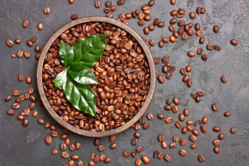 Roasted coffee beans with green leaves