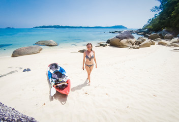 Fototapeta na wymiar woman with a kayak on an isolated beach in Andaman sea, Koh Adang - solo travel