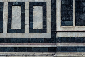 Detail of an old marble church wall close up in Firenze, Italy