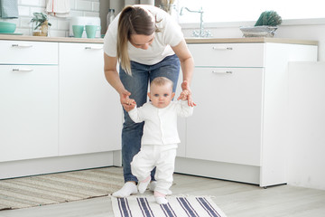 mom teaches baby to walk