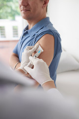 Doctor giving patient vaccine