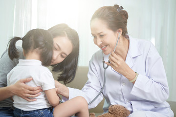 Pediatrician examining little girl
