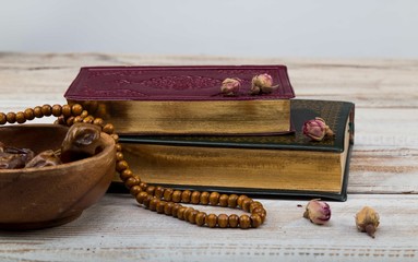 Koran - holy book of Muslims with rosary , date and dried flowers. ramadan concept