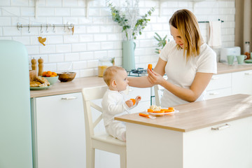 the mother feeds the baby vegetables