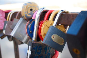 locks in the form of hearts hanging on the fence