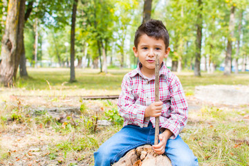 boy in the Park sitting on a log