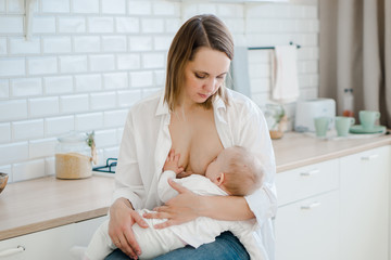Obraz na płótnie Canvas mom breast-feeds baby