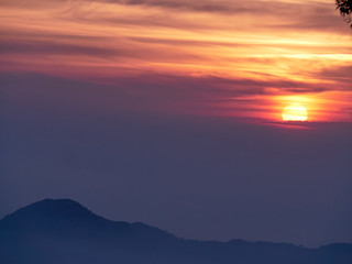 Sun set in Taiwans mountain region - Alishan mountain sun set in warm pastel colors with fog between mountain ranges