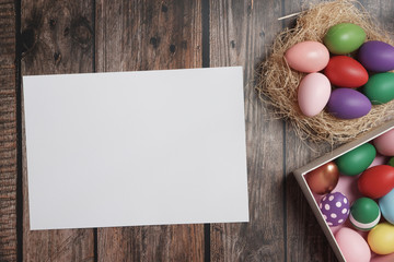 Naklejka na ściany i meble Flat-lay Easter eggs on wooden table.