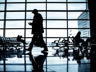 Passengers walking at a departure lounge