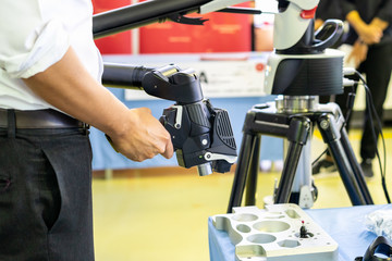 Man holding head of high technology and modern automatic 3d laser scan for measuring or reverse...