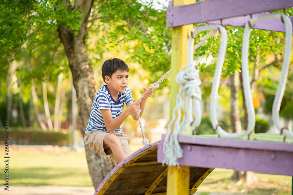 Wall mural little boy playing in the playground outdoor