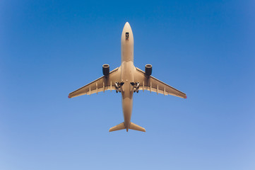 Airplane flying under blue sky and white cloud in Phuket, Thailand.