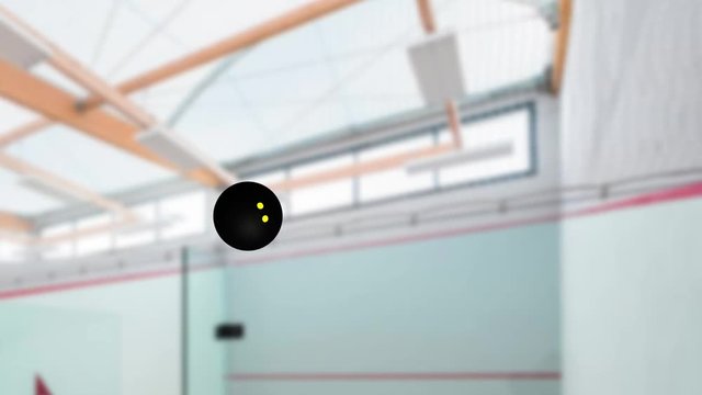 Squash ball in rotation passing right to left in slow motion inside a pitch