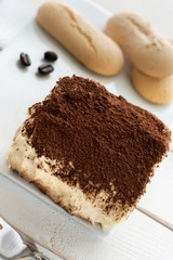 Homemade tiramisu with lady fingers on white background close up