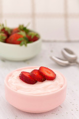 Strawberry yogurt on white background with copy space