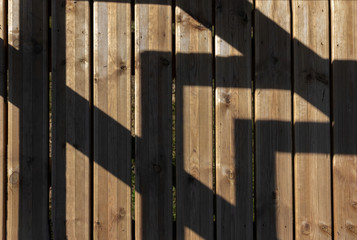 Sunlit shadows on wooden bridge