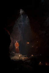 The meditation monk to follow the teachings of the Lord Buddha in the cave in Thailand.