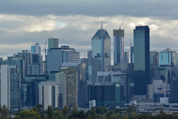 Melbourne city skyline over a moody cloudy sunrise sky