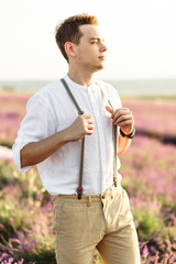 Stuning portrait of farmer in lavender field on sunset