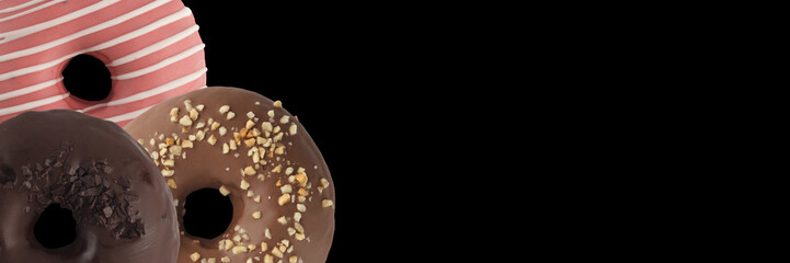 Three various donuts on a black background. Isolated Close-up.