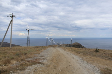 Wind generators are along the road.