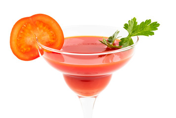 Tomato juice in a cocktail glass with a slice of tomato and parsley on a white isolated background