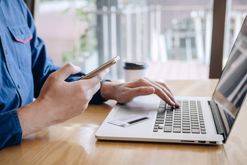Businessman holding credit card and typing on laptop for online shopping and payment makes a purchase on the Internet, Online payment, Business financial and technology