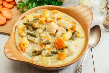 Vegetable soup with ingredients carrot, cauliflower, potato and parsley