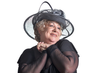 Close up portrait of beautiful senior woman in hat posing on white background