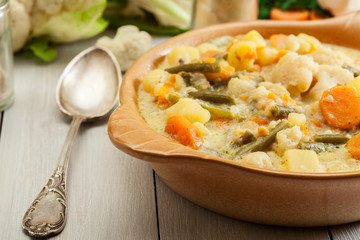 Vegetable soup with ingredients carrot, cauliflower, potato and parsley