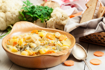 Vegetable soup with ingredients carrot, cauliflower, potato and parsley